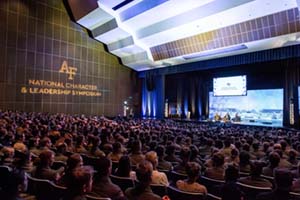 View of the stage from the back of the auditorium at the NLCS Symposium at the US Air Force Academy on Feb. 21, 2026.